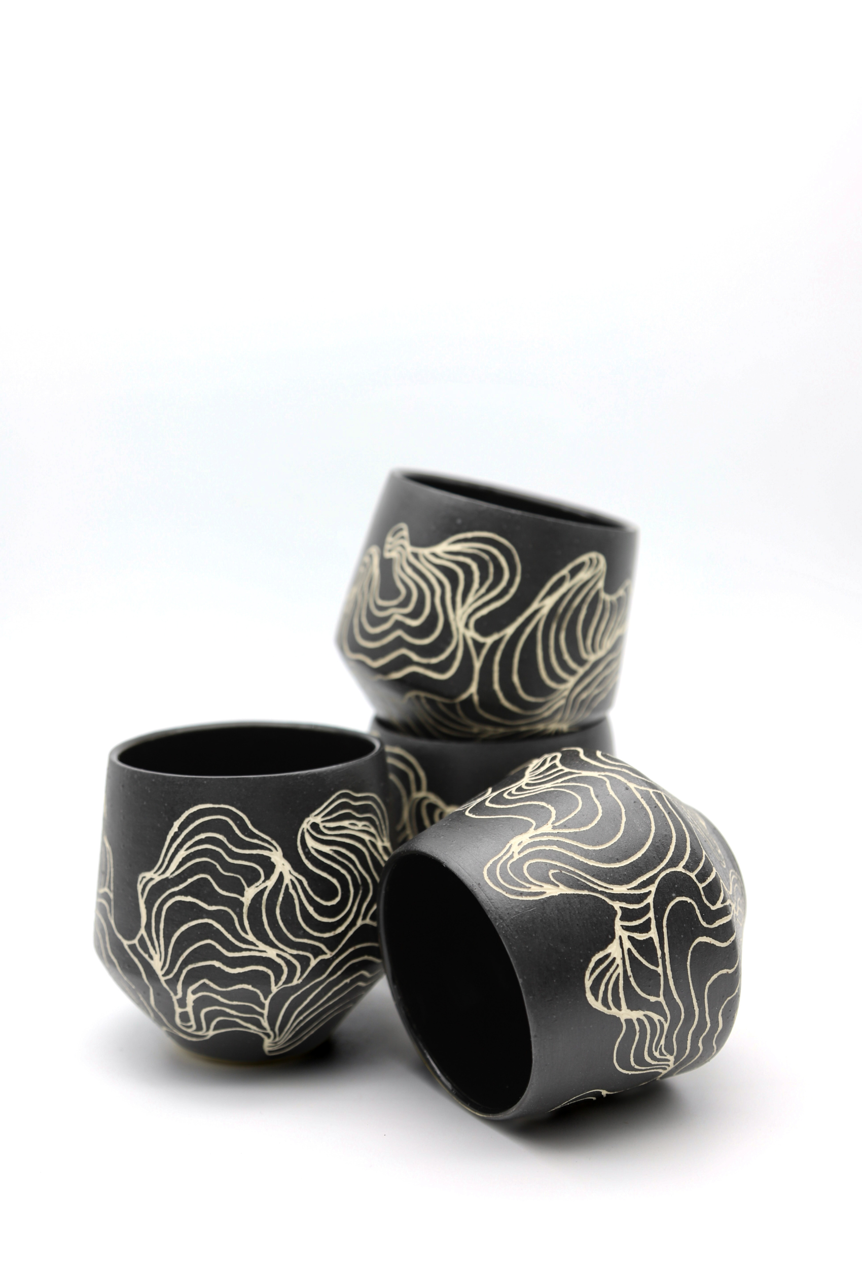 Three black and white cups